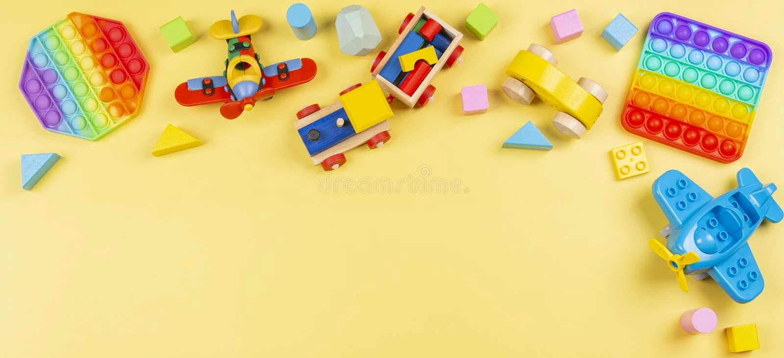 Bluey Sales Store -Bluey Sales Store baby kid toys banner background wooden blocks train car plane pop fidget toy yellow top view flat lay 222995646