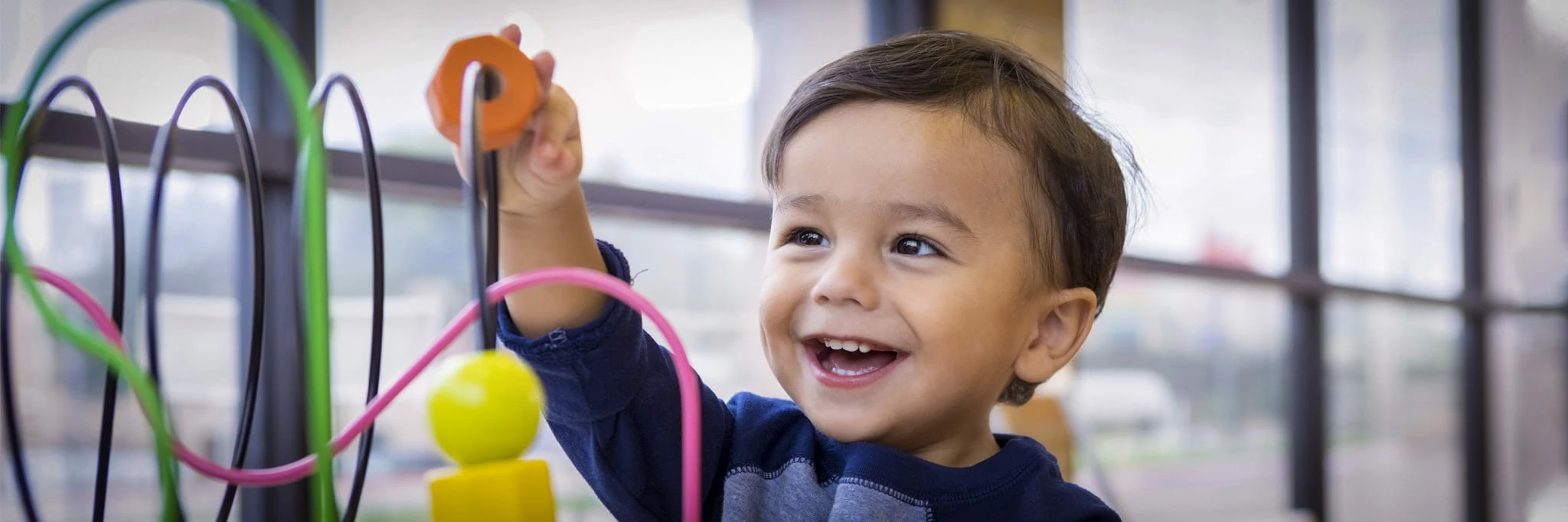 Bluey Sales Store -Bluey Sales Store young preschooler banner boy with toys at preschool